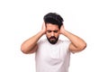 Closeup portrait young, angry, unhappy, stressed arab man covering his ears, looking up, to say, stop making loud noise it`s Royalty Free Stock Photo