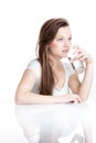 Closeup portrait of a young attractive woman drinking water