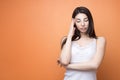 Closeup portrait of a young beautiful brunette pensive woman holding her hand new her head and looking down, think about something Royalty Free Stock Photo