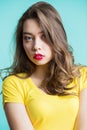 Close up portrait of a young beautiful brunette woman looking at camera, the surprised look