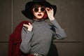 Closeup portrait of young beautiful fashionable woman with sunglasses. Lady posing on dark grey background. Model Royalty Free Stock Photo