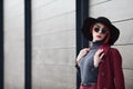 Closeup portrait of young beautiful fashionable woman with sunglasses. Lady posing on grey wooden background. Model Royalty Free Stock Photo