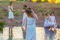 Closeup portrait of a young beautiful girl in a white dress, a floral wreath on her head. Against the background of a young bride Royalty Free Stock Photo