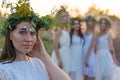 Closeup portrait of a young beautiful girl in a white dress, a floral wreath on her head. Against the background of a young bride Royalty Free Stock Photo