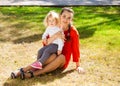 Closeup portrait of a young beautiful mother with little curly daughter in autumn park Royalty Free Stock Photo