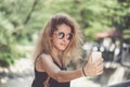 Closeup portrait of young beautiful woman in sunglasses with long blonde curly hair doing selfie photos Royalty Free Stock Photo