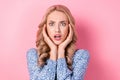 Closeup portrait of young blonde wavy hair woman confused fingers touching temples stressed staring isolated on pink Royalty Free Stock Photo