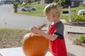 Portrait of a young boy outside carving pumpkins Royalty Free Stock Photo