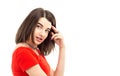 Closeup portrait of a young brunette girl in red t-shirt looking into the camera against white background Royalty Free Stock Photo