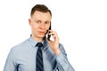 Closeup portrait of young businessman dressed in blue shirt and tie, talking on the mobile phone, isolated on white background Royalty Free Stock Photo