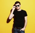 Closeup portrait of a young casual man wearing sunglasses on ye Royalty Free Stock Photo