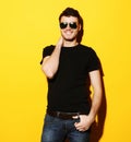 closeup portrait of a young casual man wearing sunglasses on ye Royalty Free Stock Photo