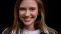 Closeup portrait of young charming caucasian female looking straight at camera and smiling with her teeth Royalty Free Stock Photo