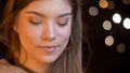 Closeup portrait of young charming caucasian female smiling with joy and happiness being seductive with bokeh background Royalty Free Stock Photo