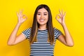 Closeup portrait of young charming japanese woman showing okey sign recommendation double symbol isolated on yellow