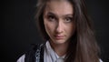 Closeup portrait of young cute caucasian female face with brown eyes and brunette hair looking straight at camera with