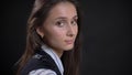 Closeup portrait of young cute caucasian female face with brown eyes and brunette hair looking turning to the camera