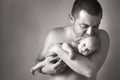 Closeup portrait of young father holding his newborn baby. Fathers day holiday, love, care concept. Royalty Free Stock Photo