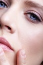 Closeup portrait of young female face. Woman with natural makeup. Finger near lips Royalty Free Stock Photo