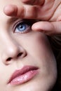 Closeup portrait of young female face. Woman with natural makeup. Hand near face Royalty Free Stock Photo