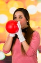 Closeup portrait of young girl clown mime blowing a balloon