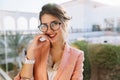 Closeup portrait of young gorgeous girl in stylish glasses, pretty student, business woman wearing elegent pink jacket Royalty Free Stock Photo