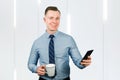 Closeup portrait of young guy businessman dressed in blue shirt and tie, talking on the mobile phone Royalty Free Stock Photo
