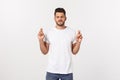 Closeup portrait of young handsome man crossing fingers, wishing, praying for miracle, hoping for the best, isolated on Royalty Free Stock Photo