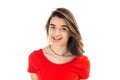 Closeup portrait of a young happy smiling girl in red t-shirt, wind blows her hair against white background Royalty Free Stock Photo