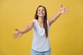 Closeup portrait, young, happy, smiling woman, motioning with arms to come, give her bear hug, isolated yellow