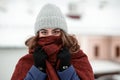 Closeup portrait of a young happy woman enjoying winter wearing scarf and knitted hat Royalty Free Stock Photo