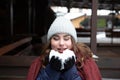 Closeup portrait of a young happy woman enjoying winter wearing scarf and knitted hat Royalty Free Stock Photo