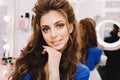 Closeup portrait young joyful woman in blue shirt with long brunette hair expressing positive emotions to camera in Royalty Free Stock Photo