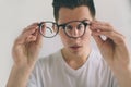 Closeup portrait of young man with glasses. He has eyesight problems and is squinting his eyes a little bit. Handsome Royalty Free Stock Photo