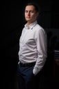 Closeup portrait of a young man, happy, cheerful, handsome businessman is standing in modern office in white shirt Royalty Free Stock Photo