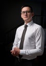Closeup portrait of a young man, happy, cheerful, handsome businessman is standing in modern office in white shirt Royalty Free Stock Photo