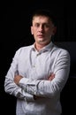 Closeup portrait of a young man, happy, cheerful, handsome businessman is standing in modern office in white shirt Royalty Free Stock Photo