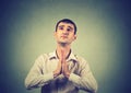 Closeup portrait young man praying hands clasped Royalty Free Stock Photo