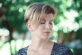 Closeup portrait of young middle aged white caucasian girl woman with short hair stylish haircut in tshirt with closed eyes Royalty Free Stock Photo