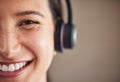 Closeup portrait of young mixed race female call center agent wearing headset. Face of smiling and friendly customer Royalty Free Stock Photo
