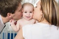 Closeup portrait of young parents kissing beautiful newborn son Royalty Free Stock Photo