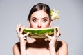 Closeup portrait of young sensual hispanic or italian woman eating watermelon isolated on gray background. Royalty Free Stock Photo