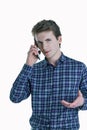 Closeup portrait of young, serious business man, corporate employee, student talking on cell phone. Royalty Free Stock Photo