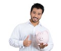 Portrait of young smiling student, worker man holding piggy bank, giving thumbs up Royalty Free Stock Photo