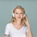 Closeup portrait of young woman closed eyes listening music via headphones on color neutral gray tone Royalty Free Stock Photo