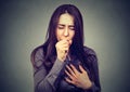 Closeup portrait of a young woman coughing