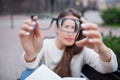 Closeup portrait of young women with glasses. She has eyesight problems and is squinting his eyes a little bit. Beautiful girl is Royalty Free Stock Photo