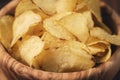 Closeup potato chips with herbs in wood bowl on rustic table Royalty Free Stock Photo