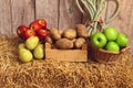 Closeup potatoes apples and pears on hay bale