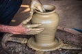 Closeup of potter`s hands making clay water pot on pottery wheel. Royalty Free Stock Photo